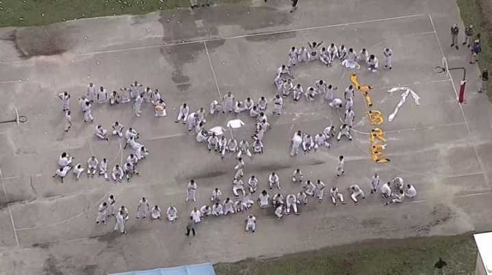 Migrants detained at Florida detention center spell "SOS" with bodies