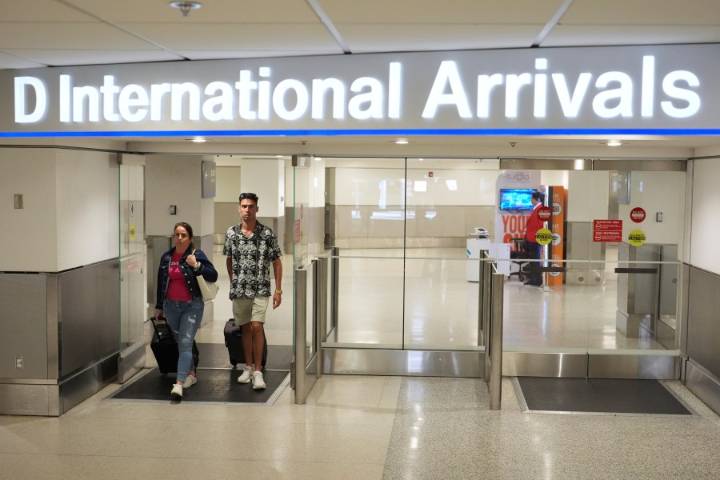 Some visitors report extra scrutiny at US airports as Trump's new travel ban begins