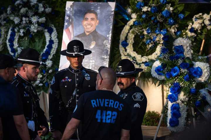 Amid flowers, stories, prayers, vigil for fallen officer allows a city to grieve