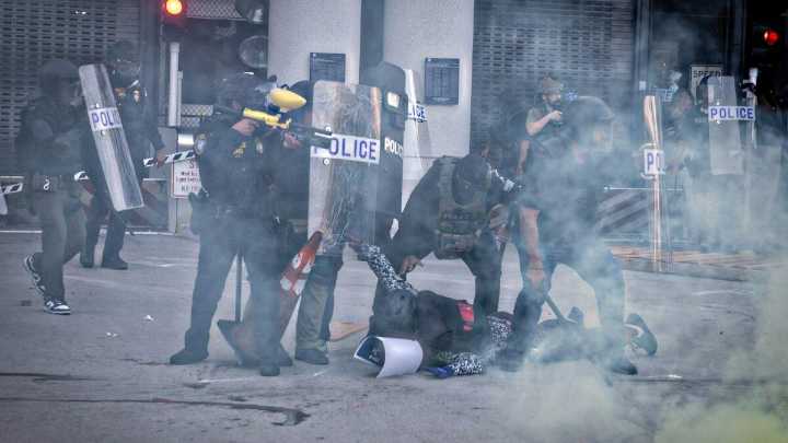 Officers Throw Flash Bangs At Crowd Protesting Immigration Enforcement