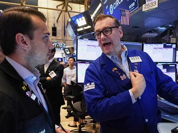 Wall Street gains ground following a solid jobs report and marks another winning week