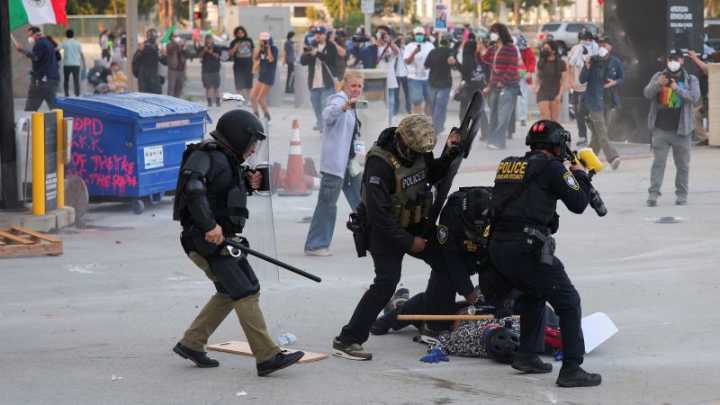 Officers throw flash bangs to disperse crowd protesting immigration enforcement in Los Angeles