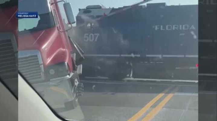 Video shows freight train slamming into stalled semi-truck in Melbourne; driver escapes unharmed 