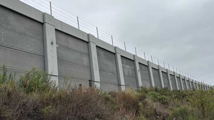 Emergency stabilization work underway on retaining wall along train tracks in Bay Ho