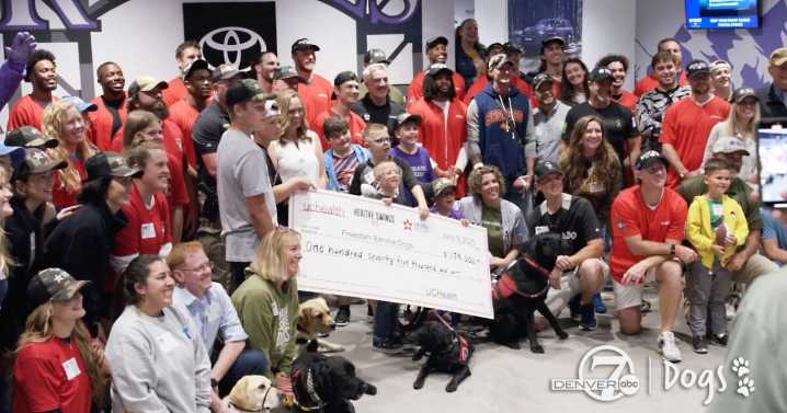 Freedom Service Dogs accepts $175K donation from UCHealth's home run derby with Denver Broncos