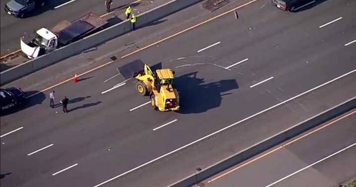 Crash sends large metal plates flying onto highway