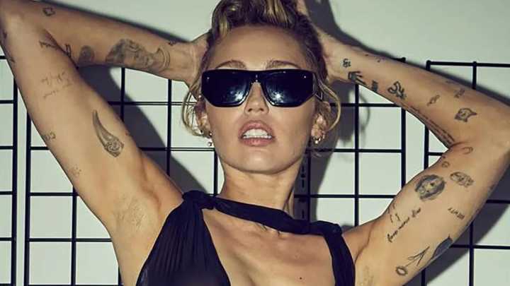 Miley Cyrus goes braless and flashes her underwear in see-through dress as she meets fans in record store