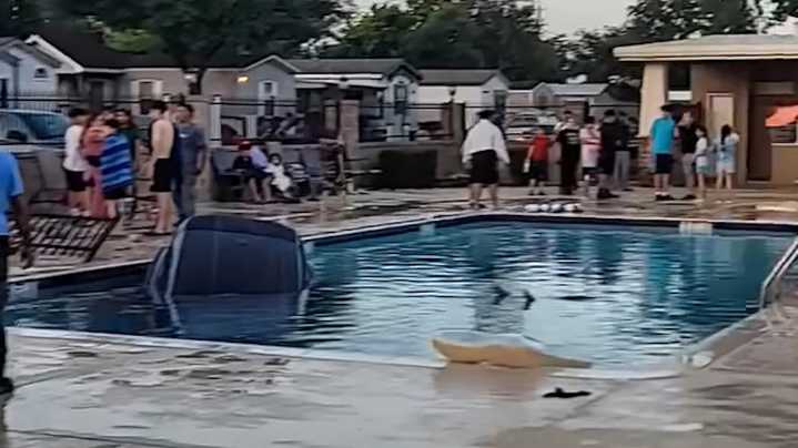 SUV crashes into Houston pool; one detained in investigation