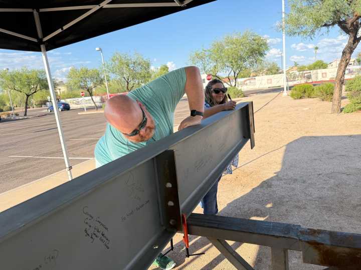 Gilbert residents leave lasting mark on advocacy center with community beam signing 