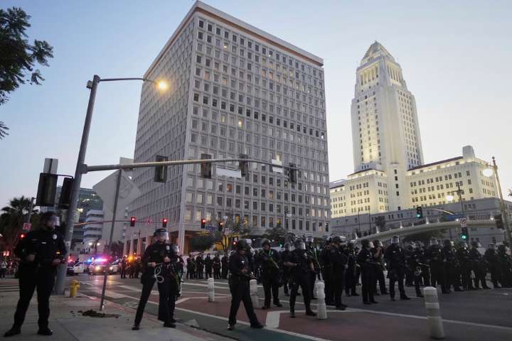 LA police enforce downtown curfew, arrest 197 as protests continue