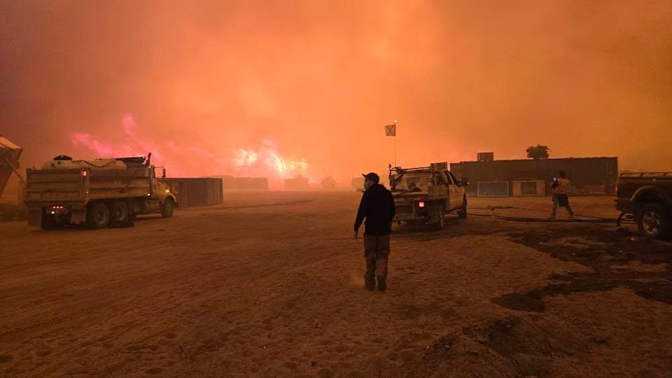 Construction workers safe after huddling in shipping container as wildfire raged around them
