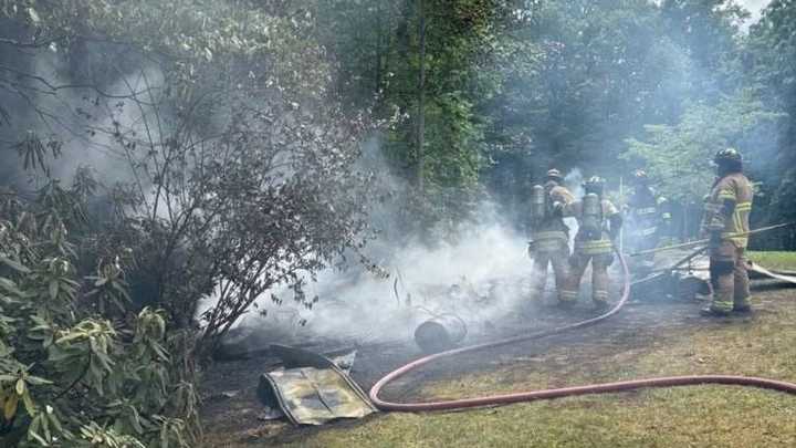 Firefighters swiftly contain outbuilding blaze, saving nearby home from potential damage