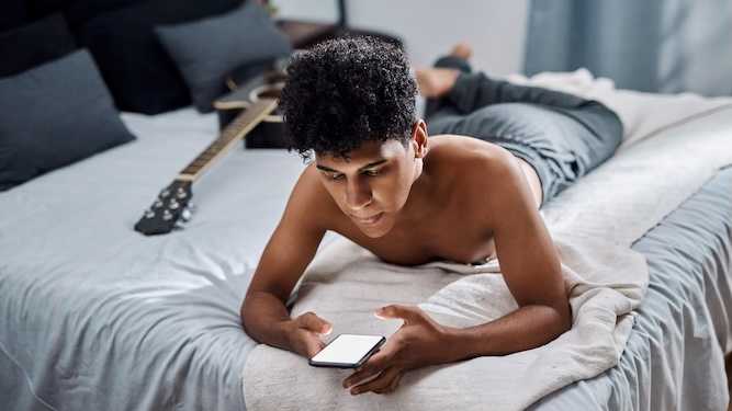 Teenage boy watching lots of Pride Month
