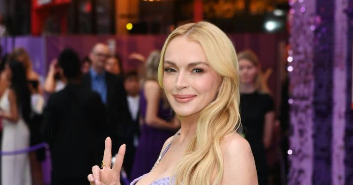 Lindsay Lohan Recreates Iconic 'Freaky Friday' Look With Guitar Bag & Metallic Dress