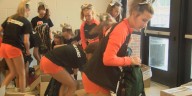 Central Junior High cheerleaders help pack 500 backpacks with school supplies