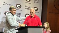Artist Steve Penley paints last 5 Georgia football coaches. See drawing