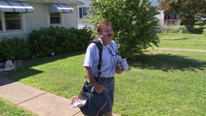 Beloved mail carrier retires after 44 years leaving behind heartfelt stamp