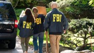 Live updates: Bolton home raided by FBI; Powell signals interest rate cut likely