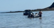 Baffled beachgoers say 'how did it get there' as car is seen submerged in water
