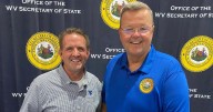 A fully registered West Virginian: Secretary of State Kris Warner assist new WVU President Michael Benson to become a registered voter in WV