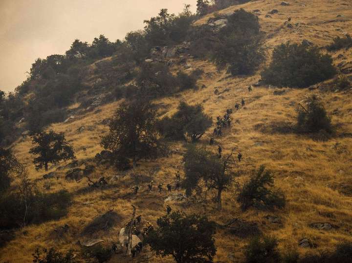 Firefighters try to corral California wildfire amid new risk