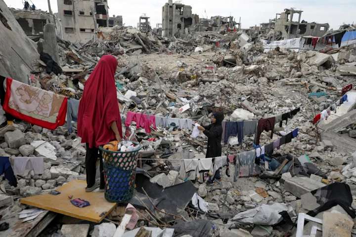 Members of the Nijim family hang laundry on the ruins of their Jabaliya house in February, amid widespread destruction caused by the Israeli military's ground and air offensive in the Gaza Strip. A ne