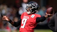 Falcons QB Michael Penix Jr. lands at bottom of pile during joint