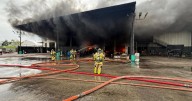Auto warehouse bursts into smoky fire in Medley, causing roof to partially collapse, Miami