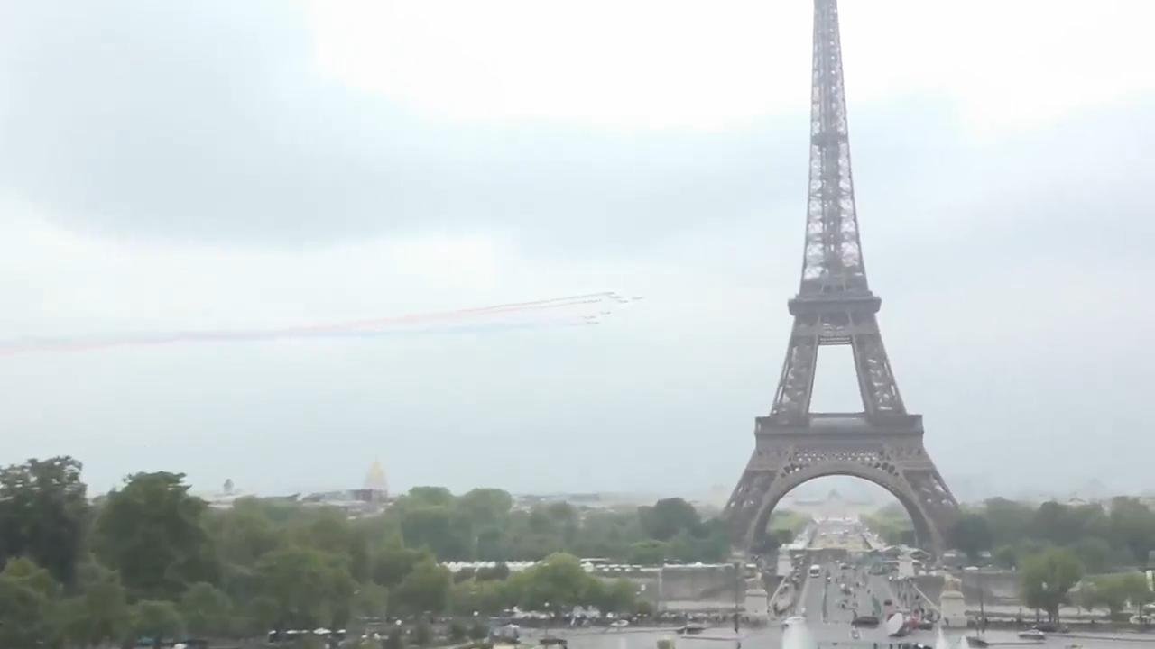 French aerobatics unit trails red, white and blue smoke past Eiffel Tower for charity event