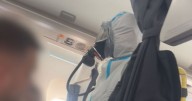 Flight 'pandemonium' as hazmat suit-clad firefighters storm British Airways plane