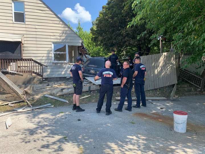 Car crashes through fence, into house in Youngstown