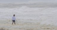 Hurricane Erin stirs up strong winds and large waves as it moves away from the US