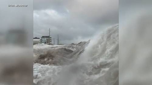 Hurricane Erin stirs up strong winds as it slowly moves out to sea