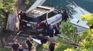 Houston police SUV crashes through fence, dangles in family’s pool in The Heights