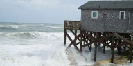 Hurricane Erin stirs up strong winds and floods part of a NC highway as it slowly moves out to sea