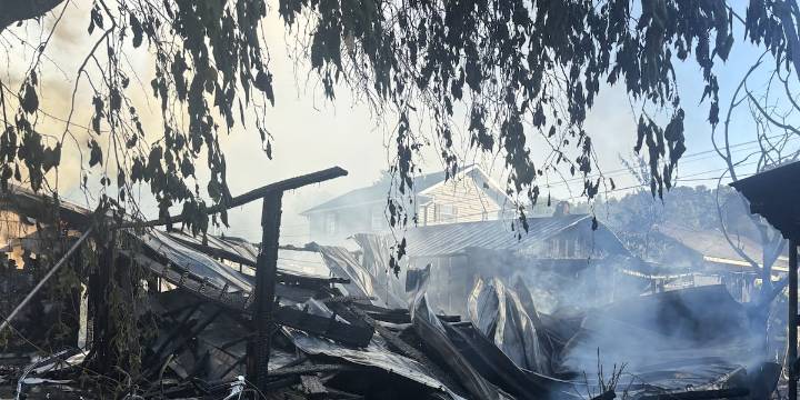 Fire destroys home, damages nearby garages; sends one to hospital