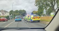 Police rush to busy Glasgow road after car 'ploughs through barrier' in 'major crash'