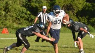 Great Plains Lutheran's Lucas Johnson finds the end zone in season opener