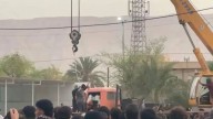 Haunting moment Iran hangs murderer from crane in front of ghoulish crowd including kids in latest grim public execution