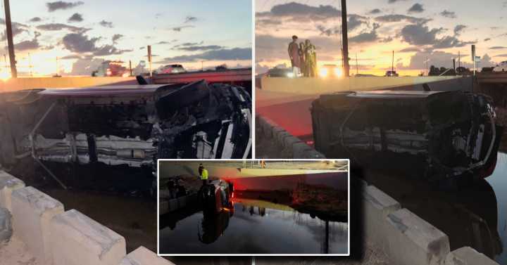 Car ends up overturned in flooded trench after veering off Papago Road