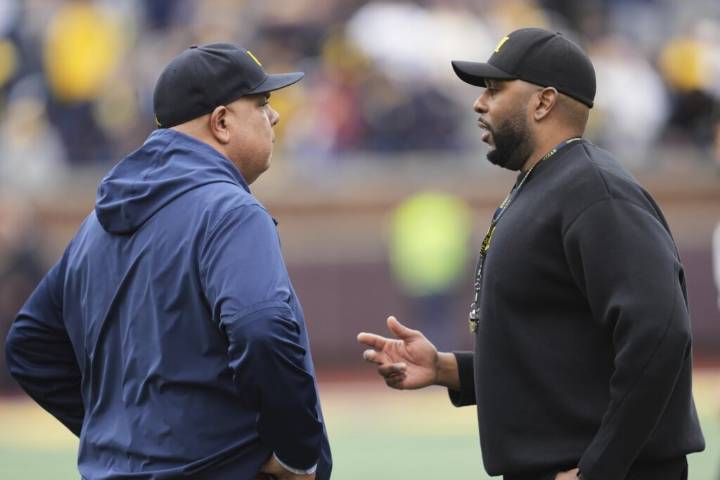 NCAA fines Michigan millions, suspends Moore 3 games over sign