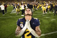 Michigan football fined millions, coach suspended 3 games in sign