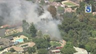 Grass fire threatens structures in Northridge