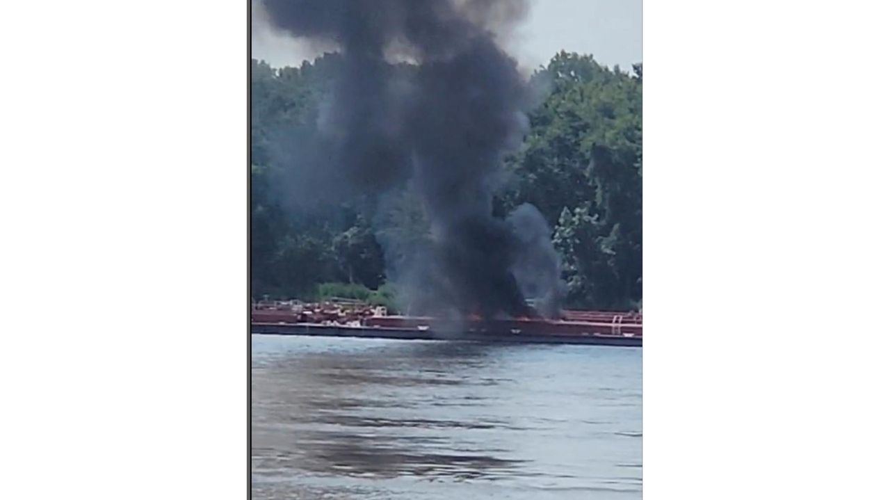 Two die when helicopter strikes powerlines and crashes into a barge on the Mississippi River
