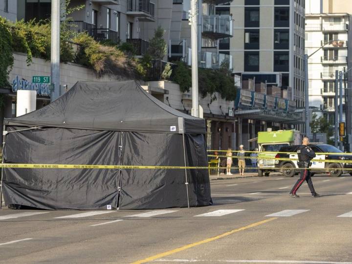 Shots ring out, woman found dead in SUV on Jasper Ave.: Edmonton police