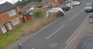 'We thought someone had died': Horrifying CCTV shows hatchback wipe out parked cars and lamppost