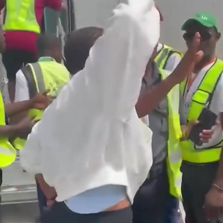 Moment plane passenger bundled screaming onto airport bus after punching stewardess & 'refusing to turn off her phone’