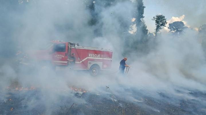 Pasture fire burns in Newton, officials urge caution