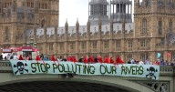 Climate activists unfurl banner from Westminster Bridge