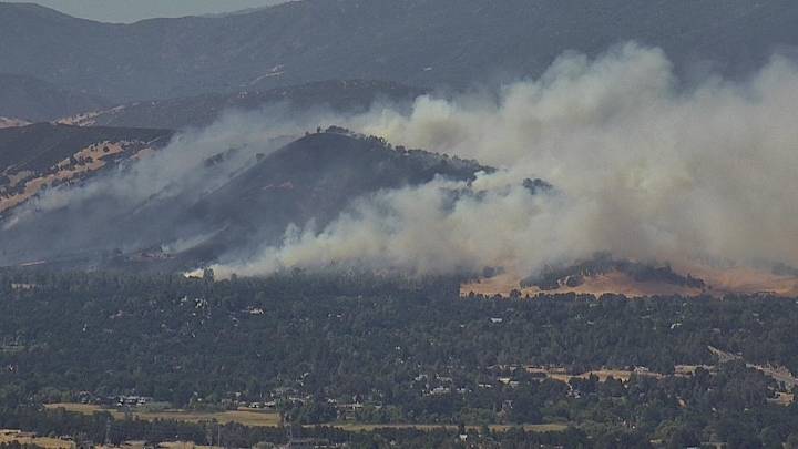 Large rush fire burning buildings in Clearlake